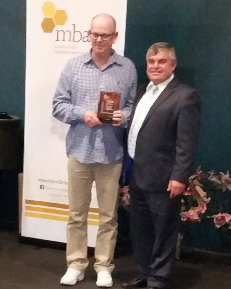 Colin Bell receiving a Marrickville Business Association award
