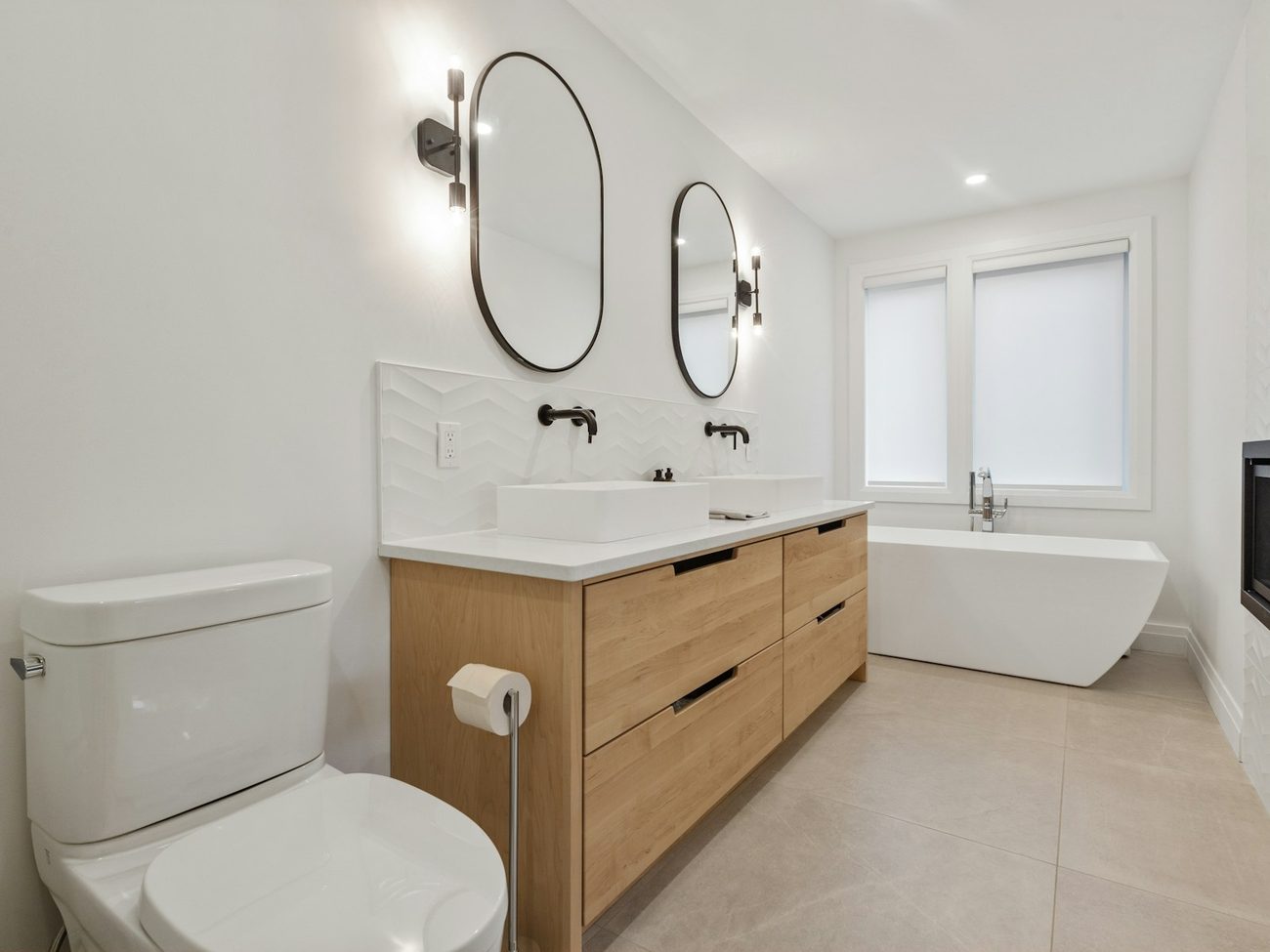 Renovated bathroom with double vanity, freestanding bath and wall-mounted tapware